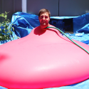 Man Explodes Out Of A Giant Water Ballon In Slow Motion… [VIDEO]